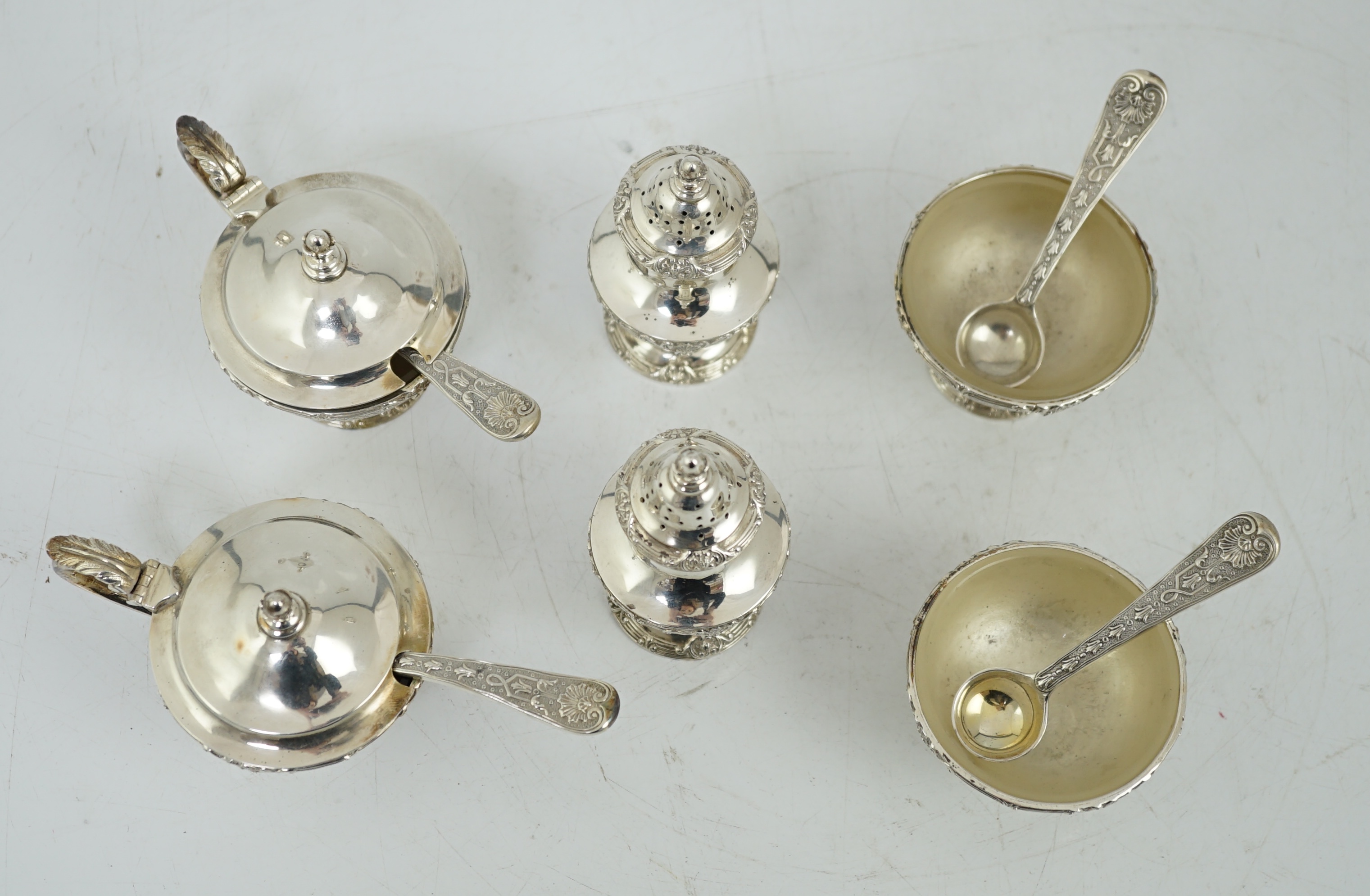 An Elizabeth II cased silver six piece pedestal condiment set, with four matching spoons, by Garrard & Co